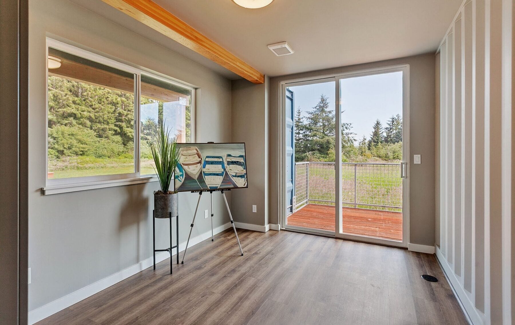 Bright and spacious shipping container home interior showcasing modular design, large windows, and eco-friendly features.